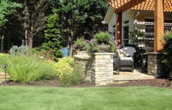 house with a flagstone patio and stone walls surrounding the patio