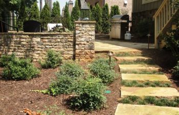 flagstone paver leading to a flagstone patio with an outdoor kitchen