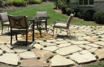 a flagstone patio with a table and four chairs