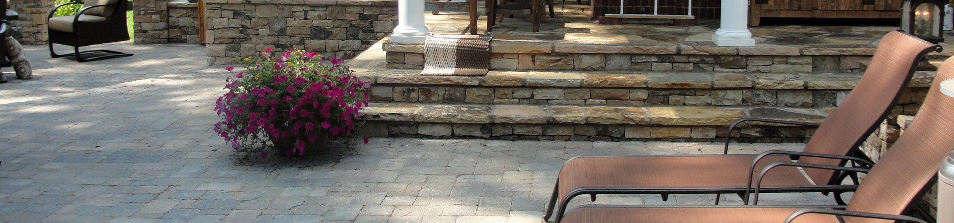 a flagstone porch and paver patio