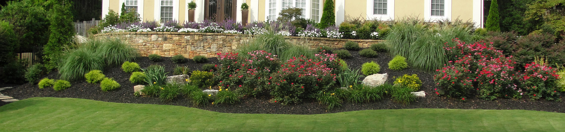 well-cared backyard with manicured lawn and plants