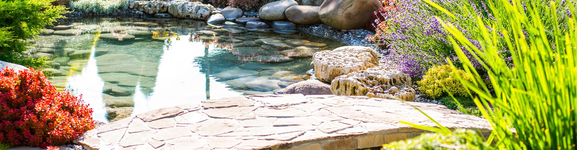 a flagstone bridge over a garden pond